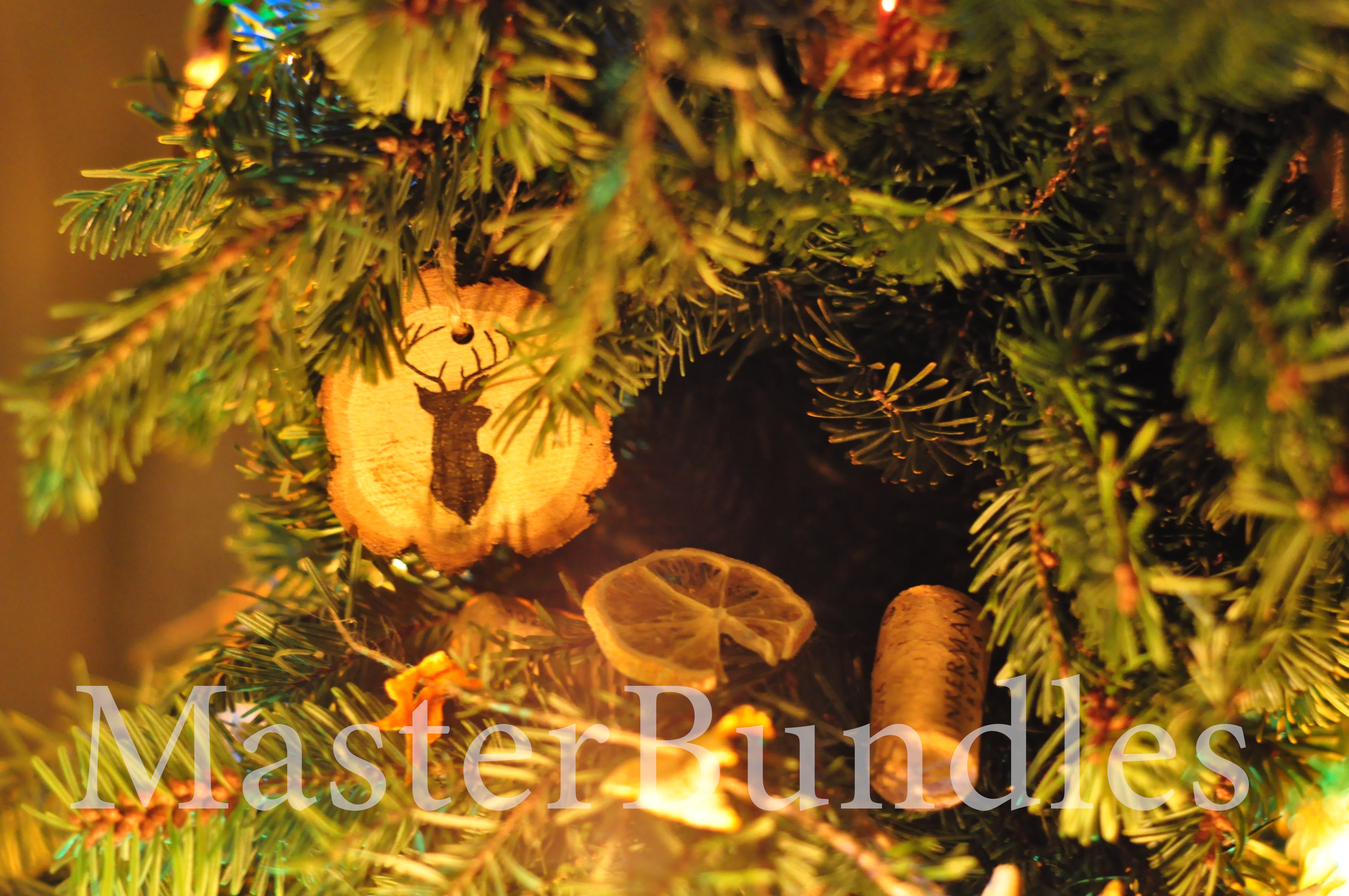 A pine branch on which the light from a lamp falls and a wooden Christmas tree toy.