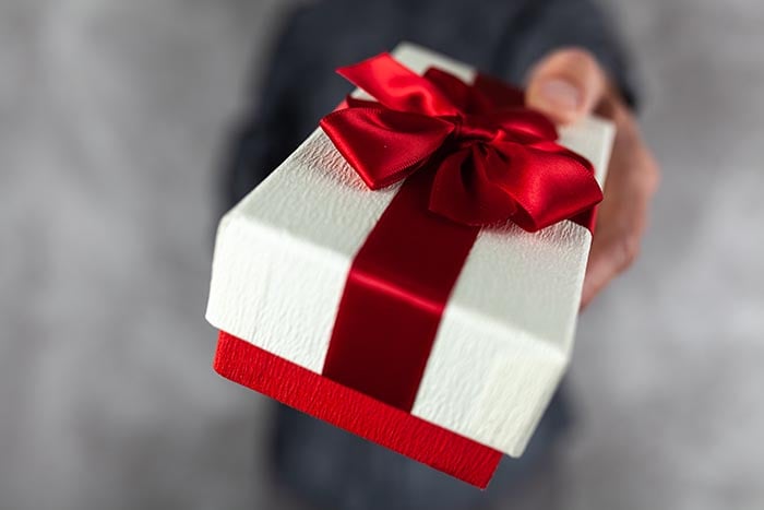 Man holding a gift box in his hands.
