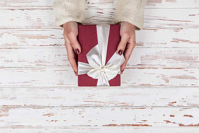 Red box for gifts in the woman hands