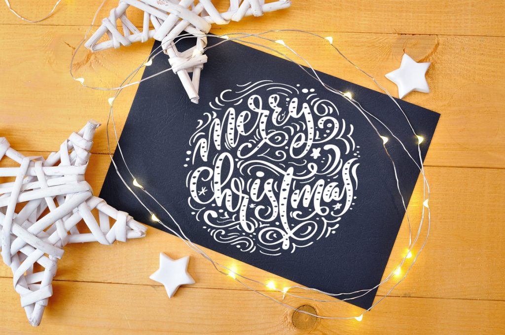 Black Christmas card with a festive font.