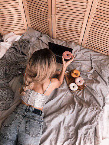 Blonde girl with donuts in a cozy room.