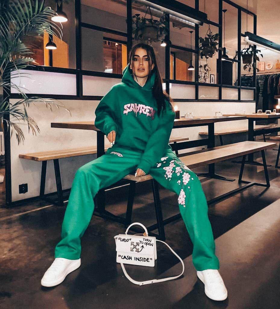 The casual style of a girl in a green tracksuit combined with a luxurious handbag looks incredible.