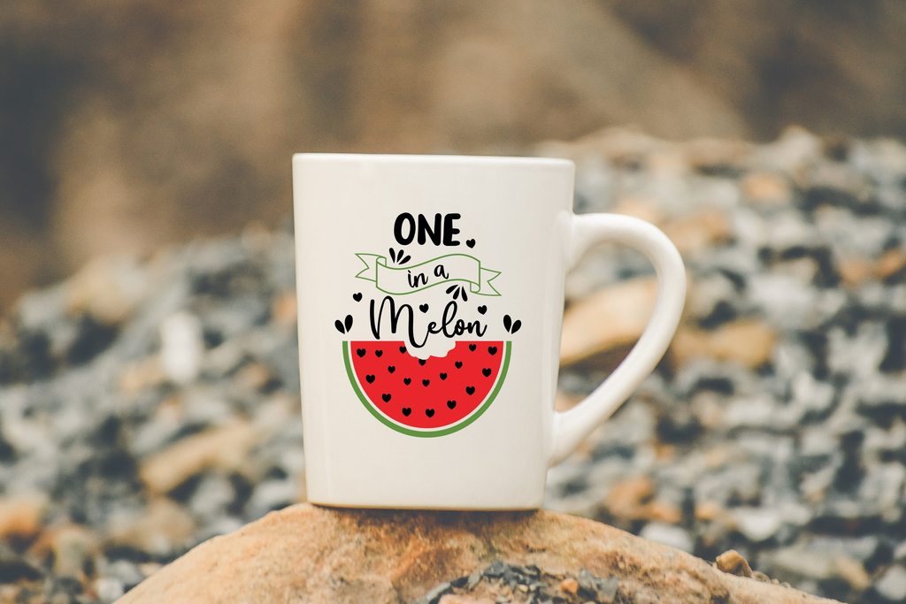 White cup with a picture of a watermelon and a thematic inscription.