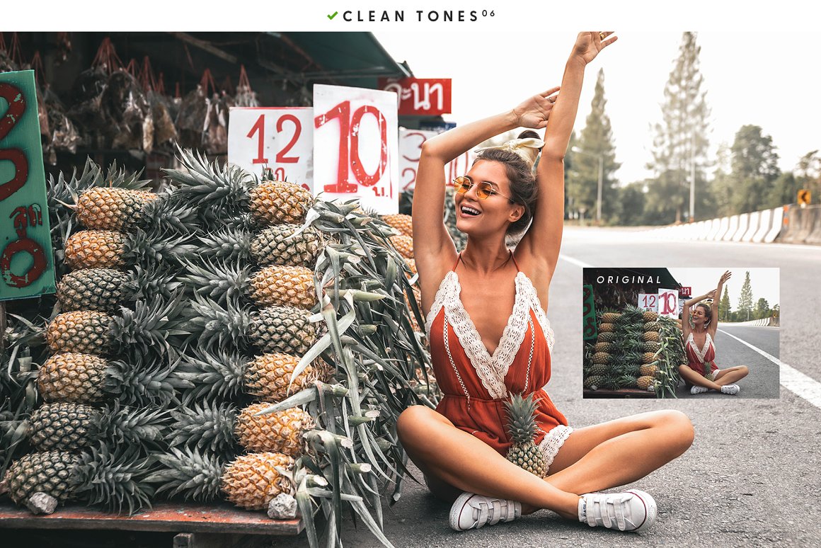 A beautiful young girl is sitting next to a mountain of pineapples.