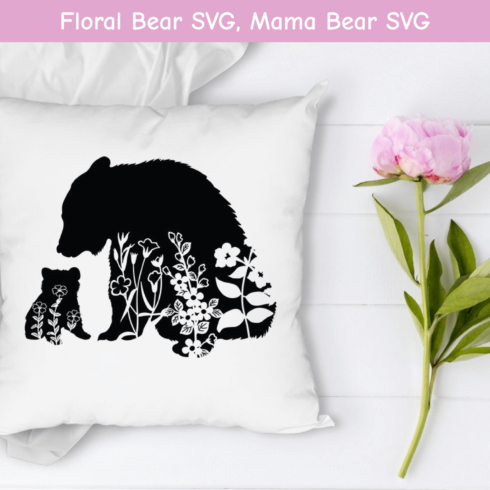 Pillow with a bear and cub silhouette on it.