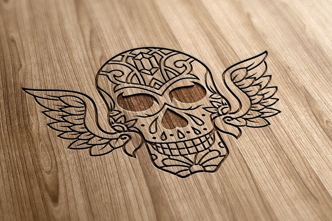 Winged skull carved on a board.