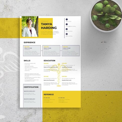 Yellow and white resume is on a table.