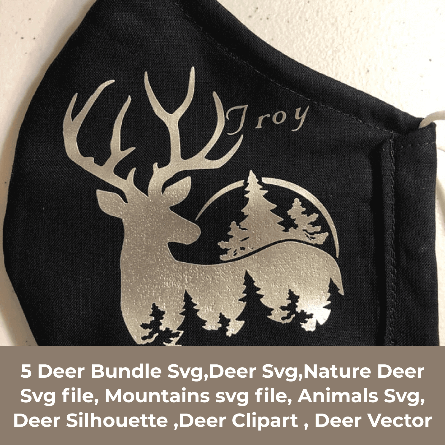 Black face mask with a deer and pine trees on it.