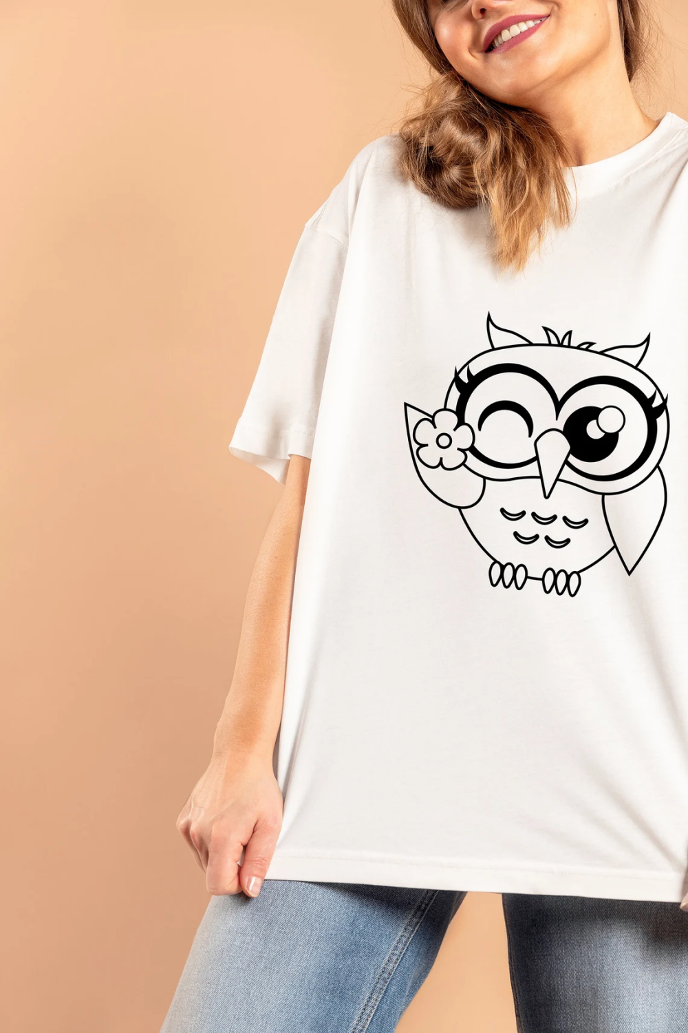 Woman wearing a t - shirt with an owl on it.