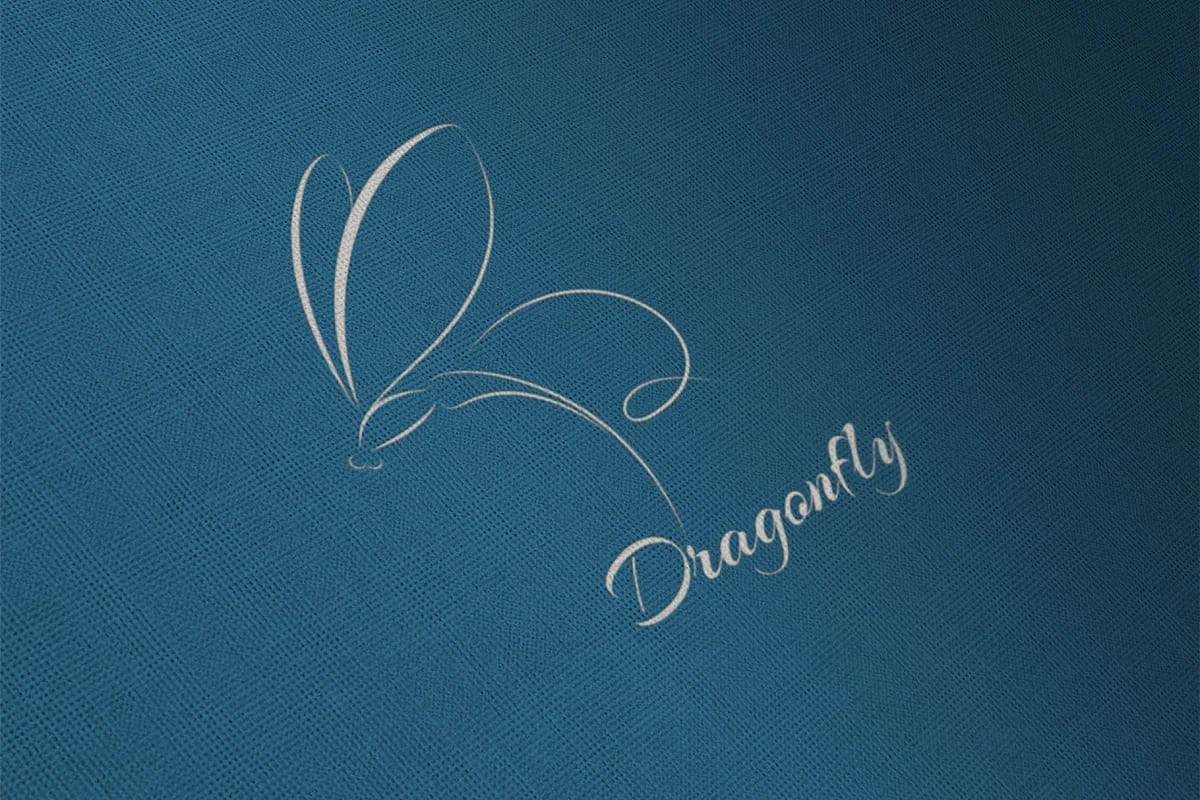 dragonfly white logo on blue cloth.