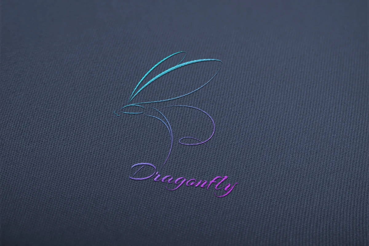 dragonfly rainbow logo on dark blue cloth.
