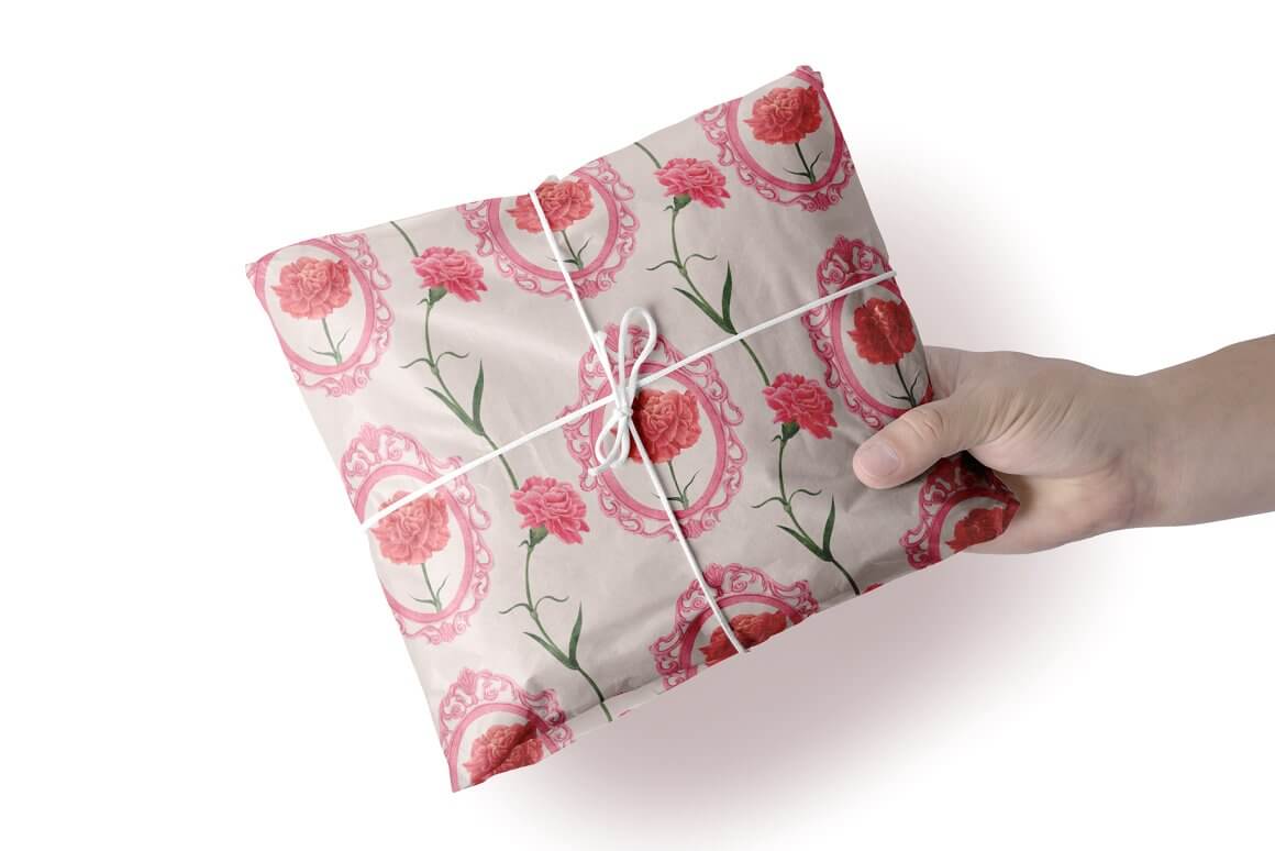 A gift wrapped in coffee gift paper on which carnations are drawn and tied with a light cord.