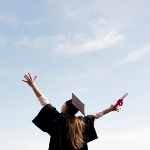 A picture of a graduate with outstretched arms.
