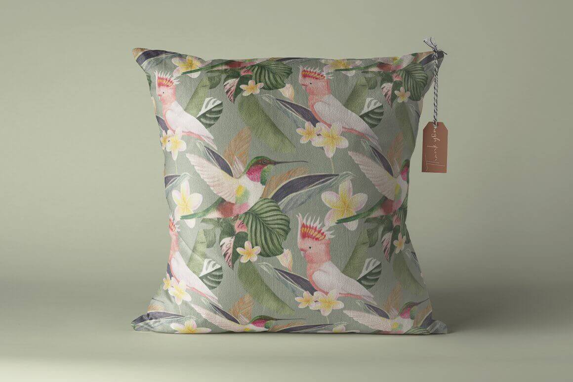 Pillow with the image of tropical birds: hummingbirds, parrots.