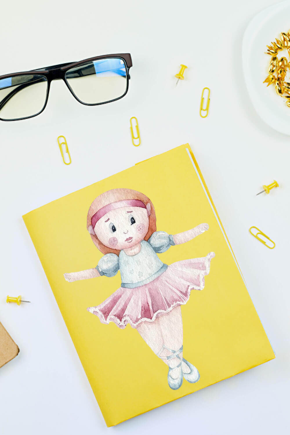 Yellow postcard with a drawn ballerina on it.