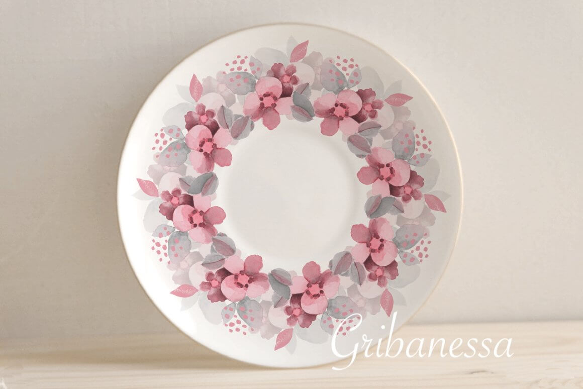 The plate is decorated with a pattern of pale pink flowers and gray leaves.