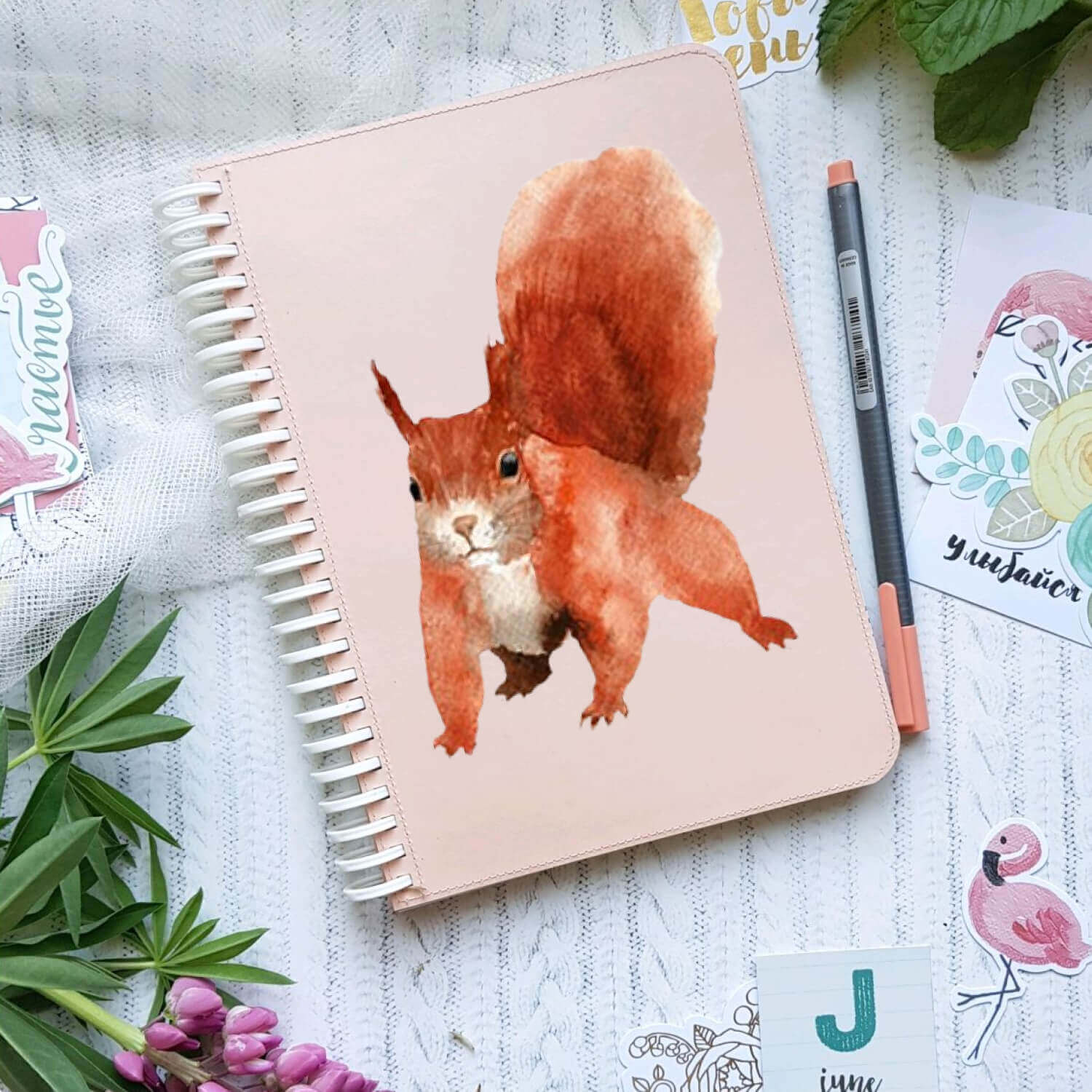 Image of a squirrel painted in watercolor on a notebook.