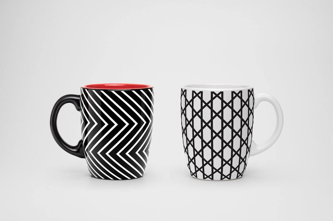 Samples of geometric seamless patterns on two black and white cups.