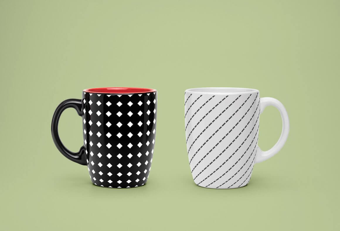 White and black cups with a geometric design on a green background.