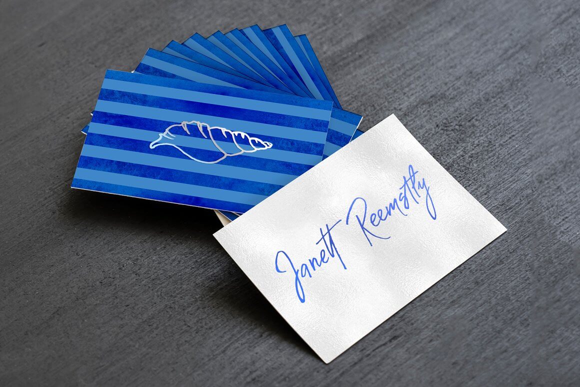 Blue cards with a croissant design, one white card with the name Janett Reemstly.