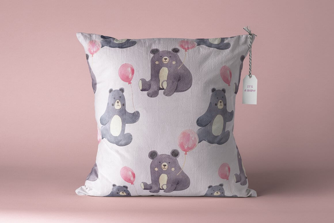Baby pillow with a bear on a pink background.