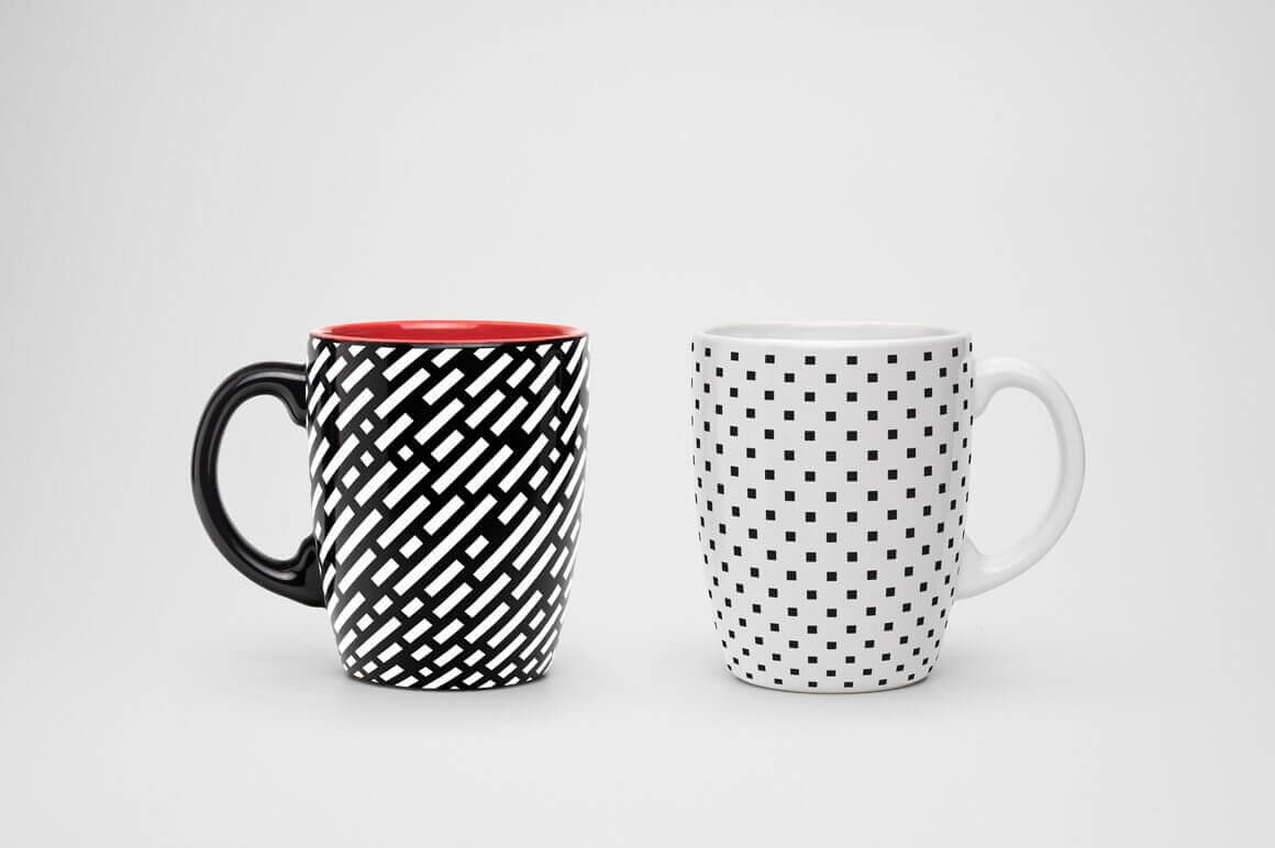 The white cup has square dots and the black cup has jagged white diagonal stripes.