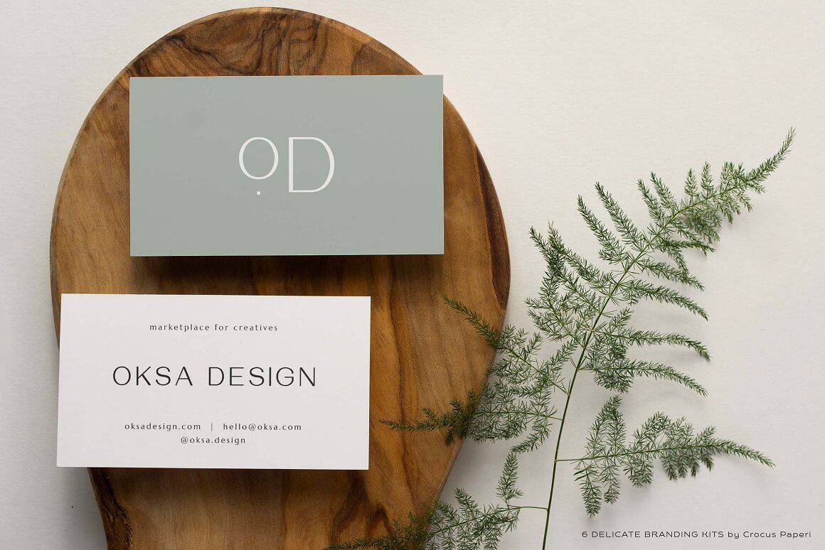 There is a fern leaf next to Oksa design business card.