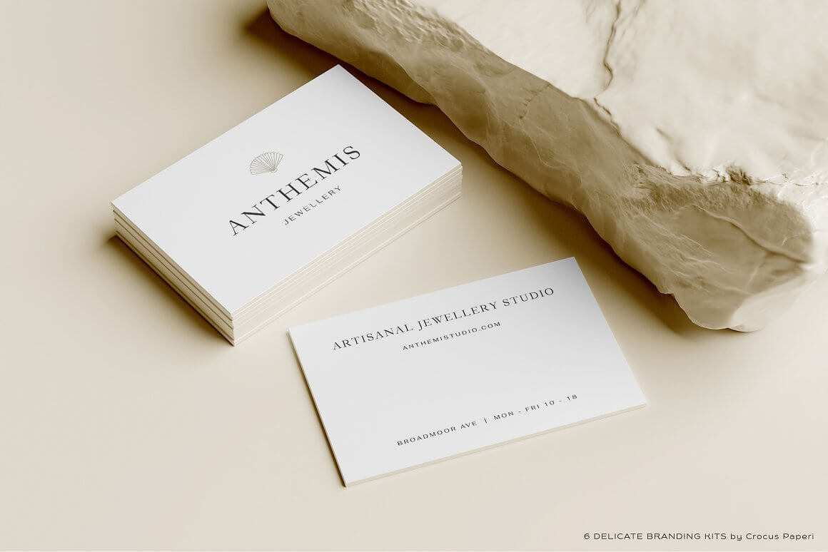 Anthemis studio's business card is shown on both sides against a soft beige background.
