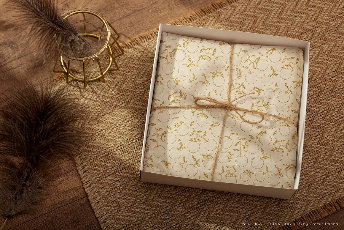 The white box contains gift paper with a citrus print.