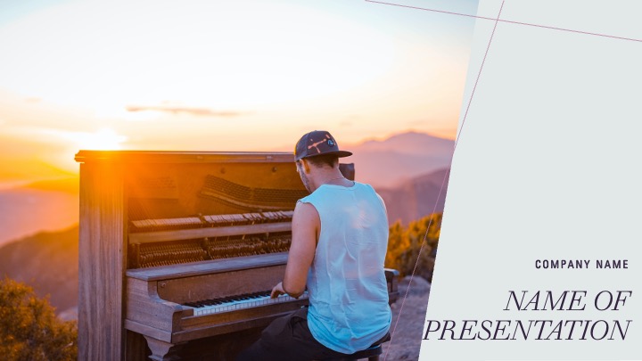 A man in a cap plays the piano at sunset.