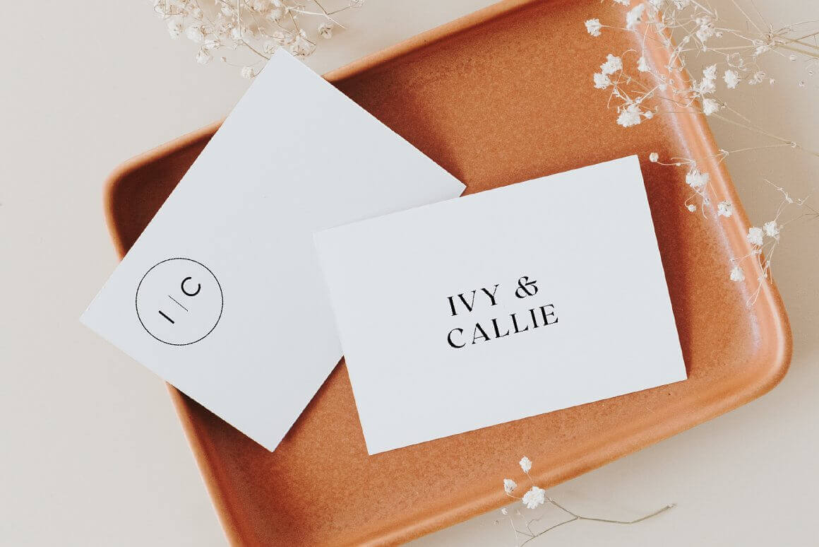 Two cards with variations of the Ivy & Callie logo are on a beige plastic tray.