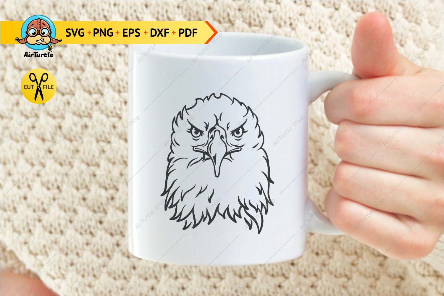 Person holding a coffee mug with an eagle on it.