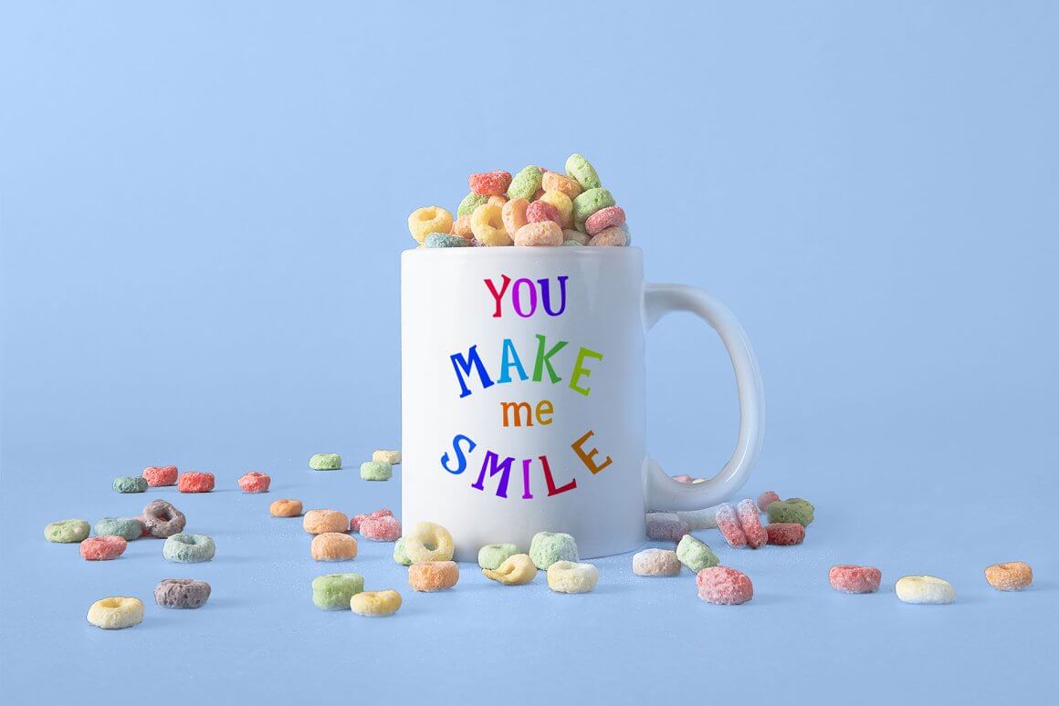 A white cup with the inscription you make me smile, a cup full of delicious airy cereal.