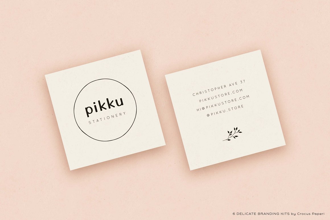 Pikku business card on both sides on a peach background.