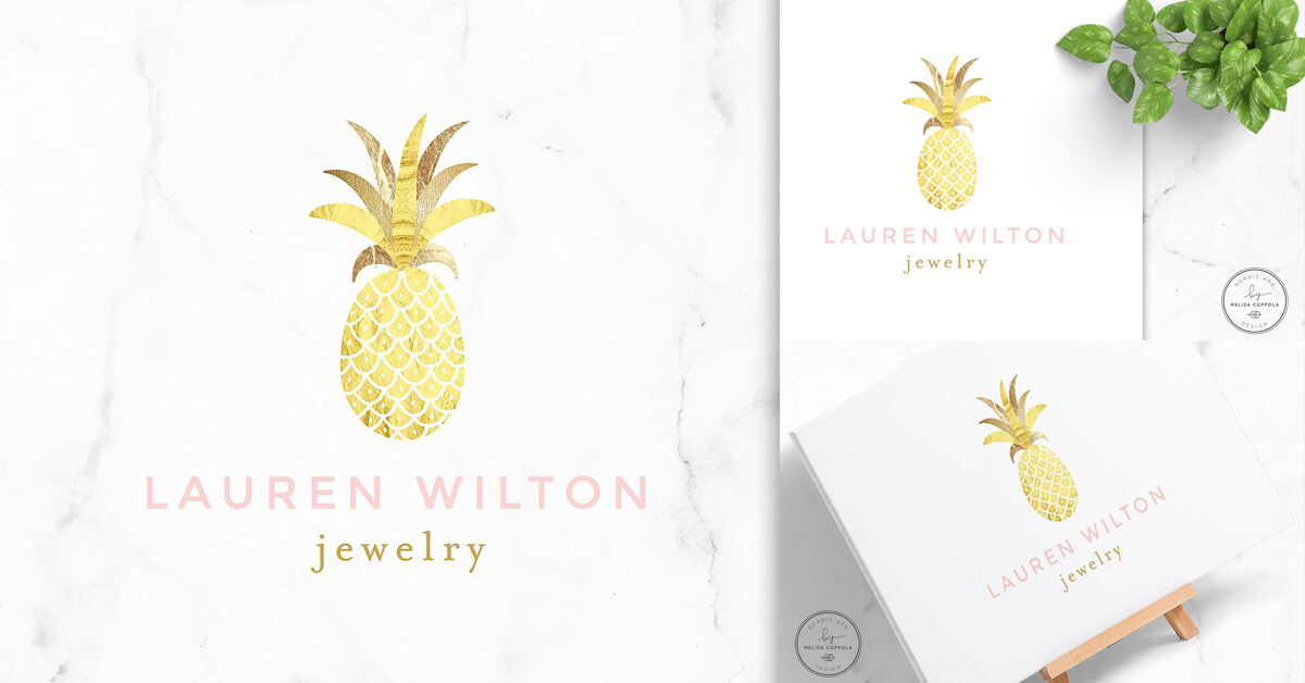 Logo drawing of golden pineapple on white marble, on canvas and card.
