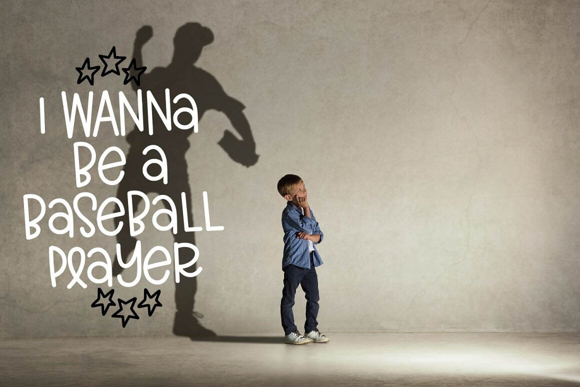 The boy stands against the background of a large wall with a large shadow and thoughts about a basketball career.