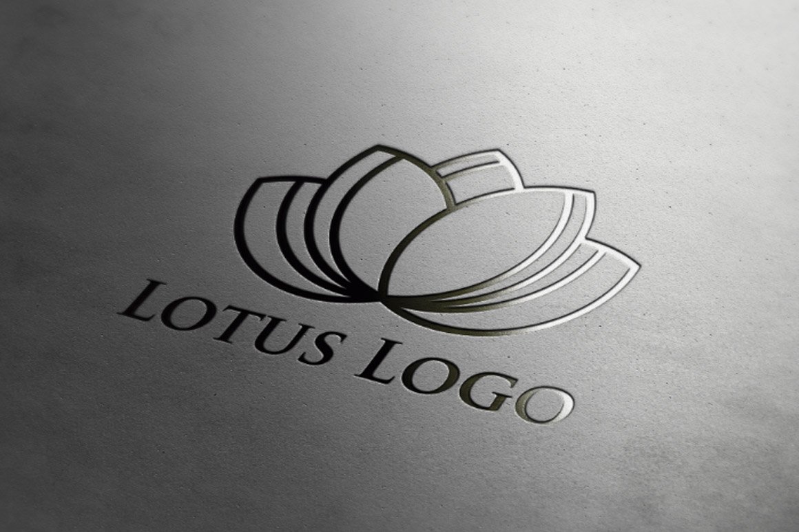 Silver logo with lotus flower close up at an angle.