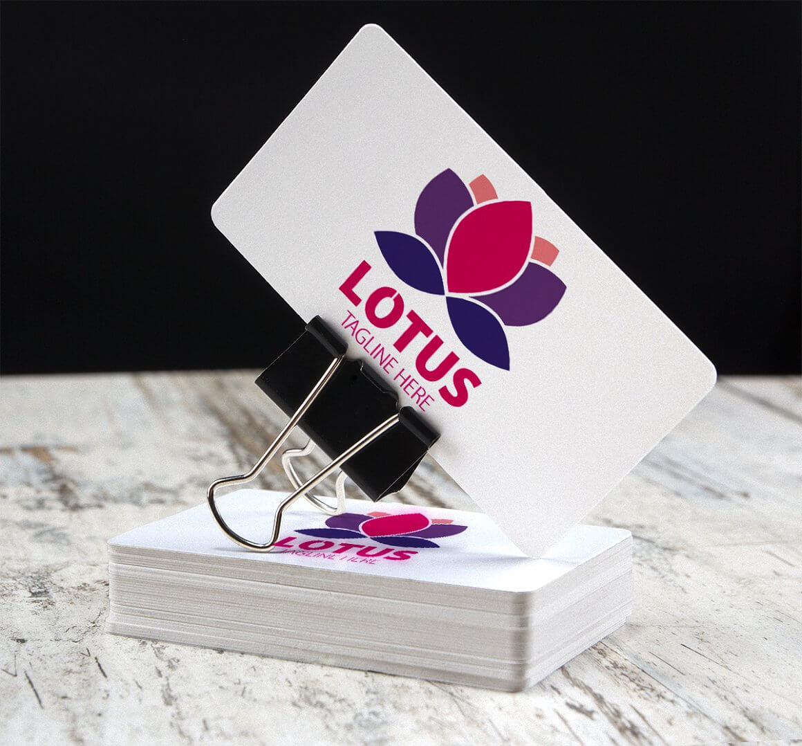 Colored Lotus Tagline Here logo on business cards.