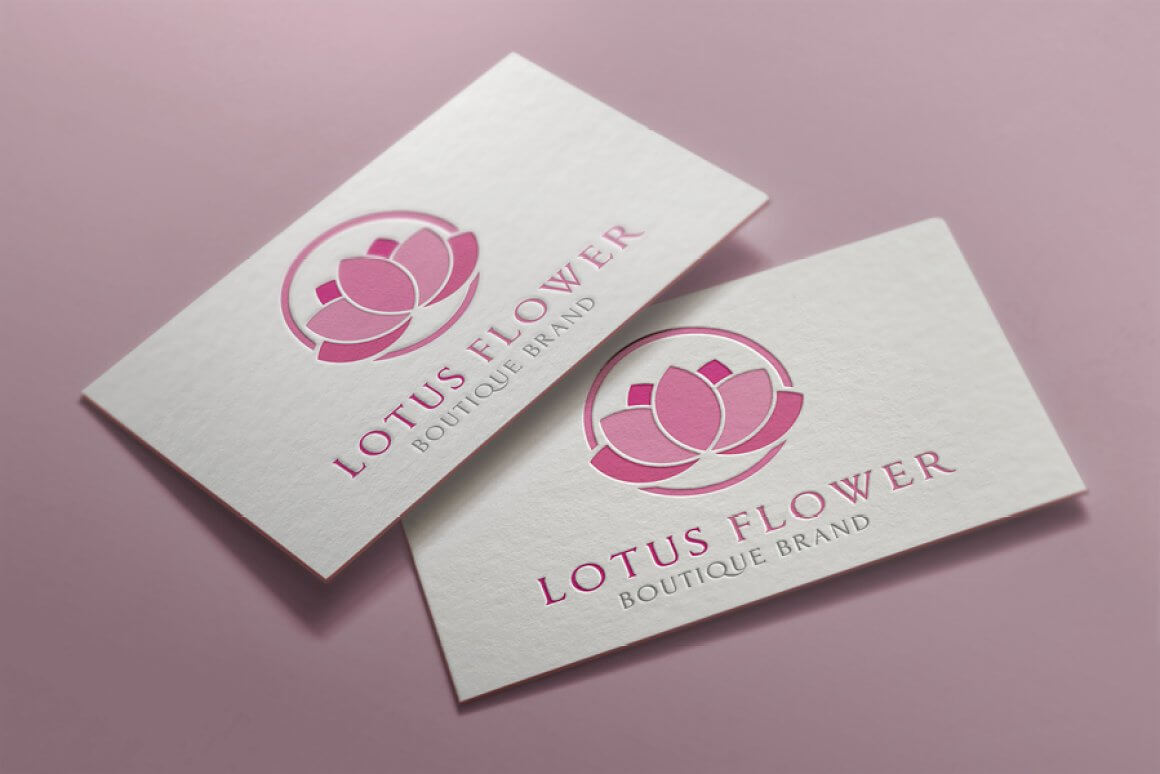Pink lotus flower logo on white business cards.