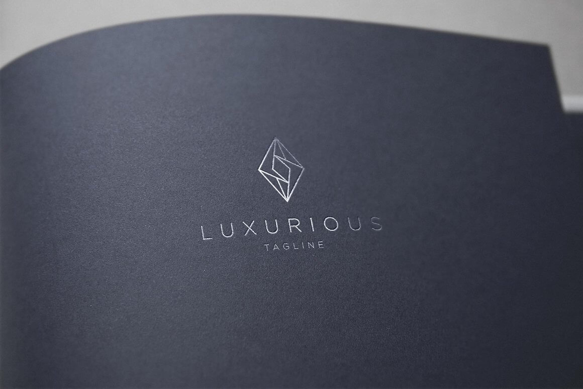 Curved gray leaf with luxury jewelry logo.