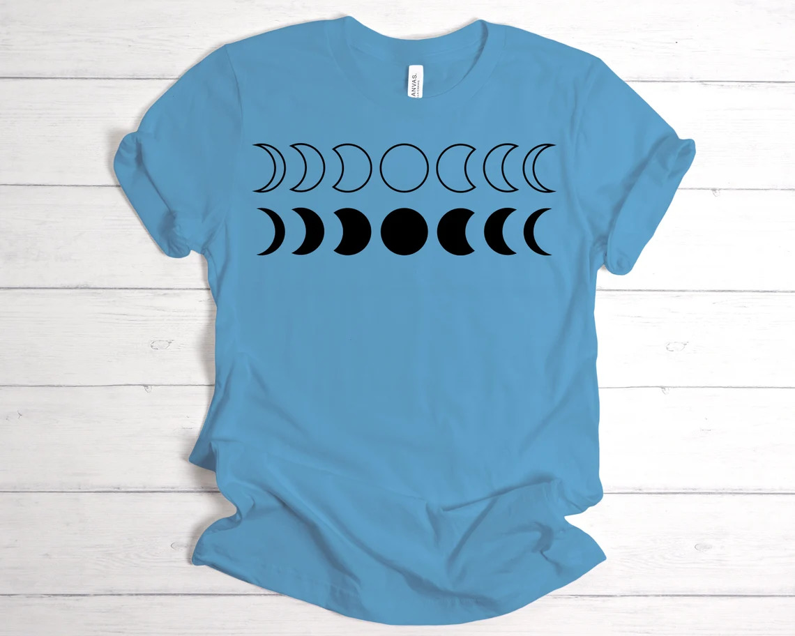A blue t-shirt with the moon in different moods.
