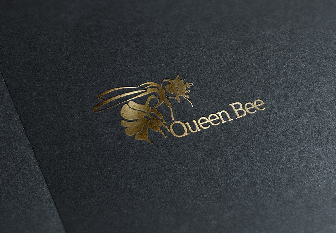 Golden glossy bee on a gray matte background.