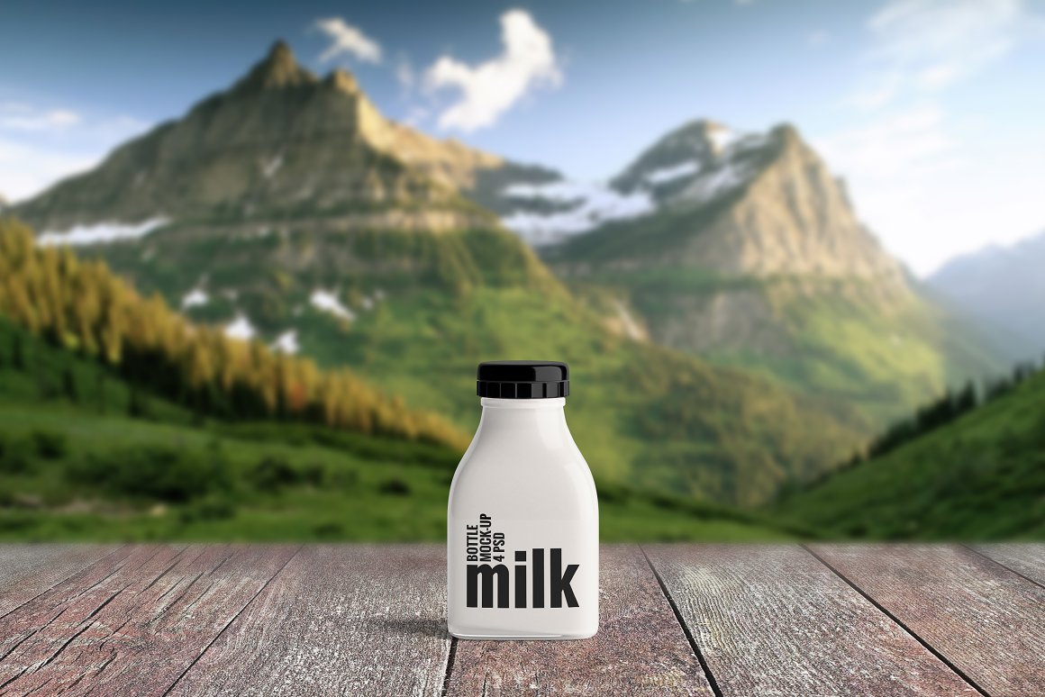 A white bottle with a black print on a background of mountains.