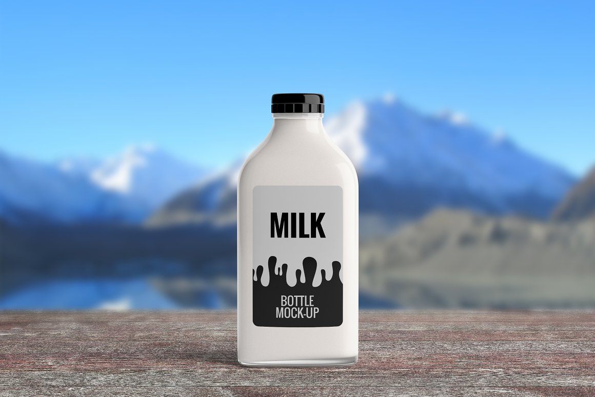 A white bottle with a black print on a background of mountains.