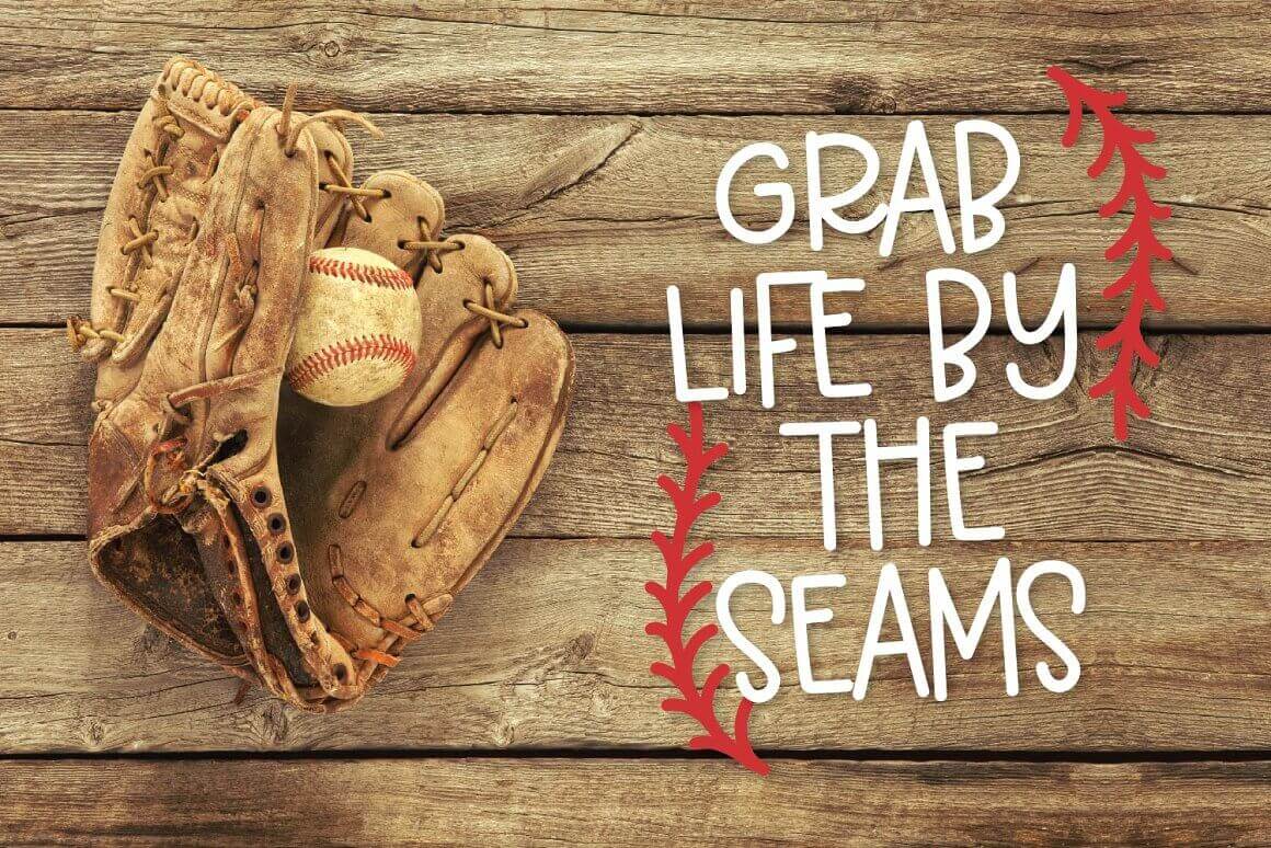 Baseball, glove and "Grab life by the seams" written on the wooden floor.