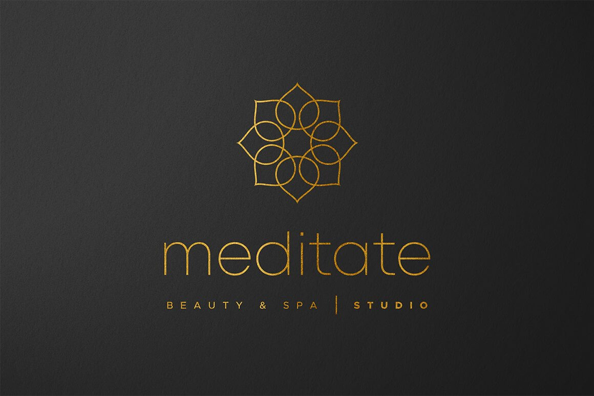 Logo of a beauty and spa studio with the image of a golden lotus and the inscription meditate on a black matte background.