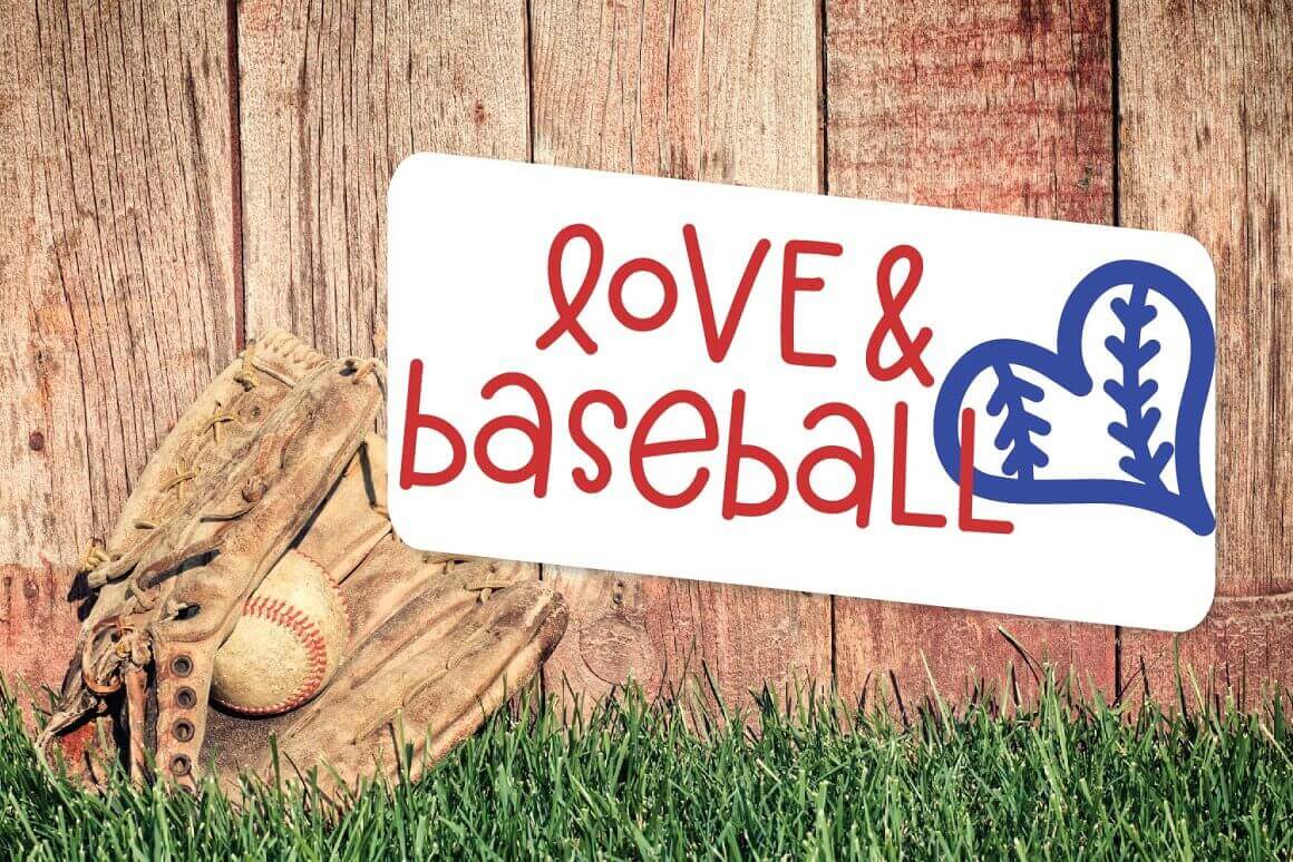 A baseball glove with a ball lies on the grass near a wooden fence and the inscription "Love & baseball" on a white background.