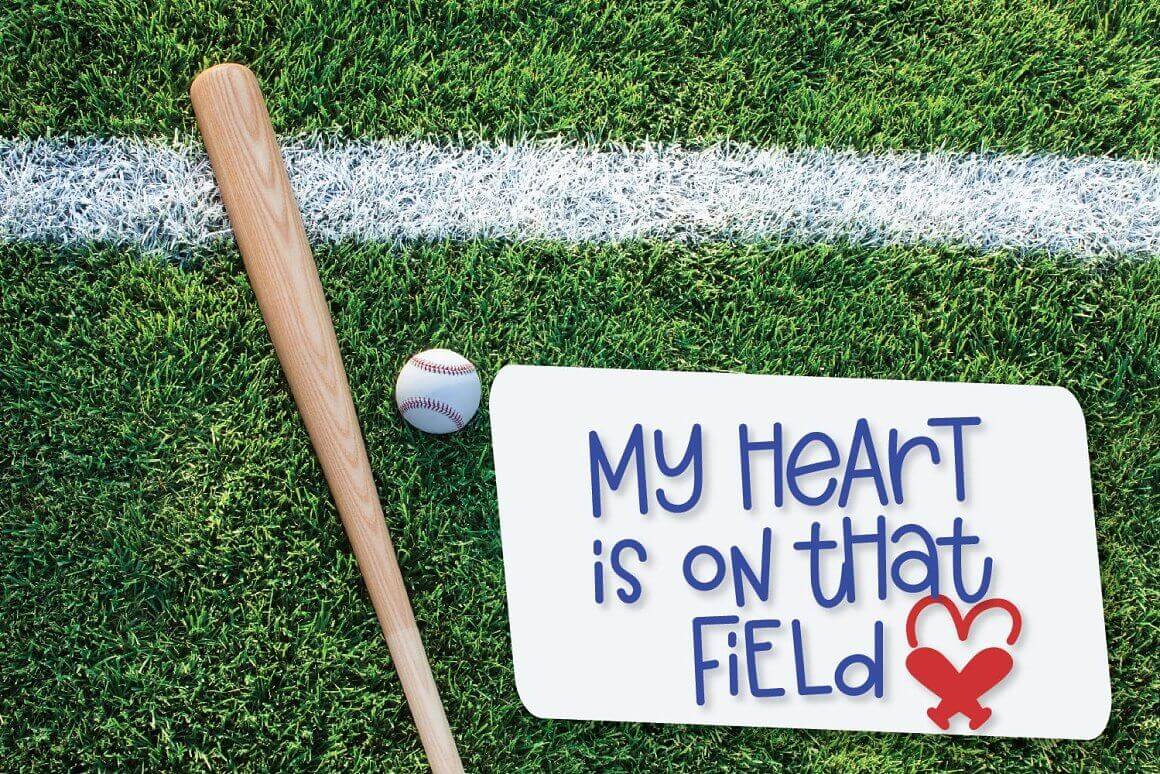 Baseball bat with a ball on a sports lawn and the inscription "My heart is on that field".