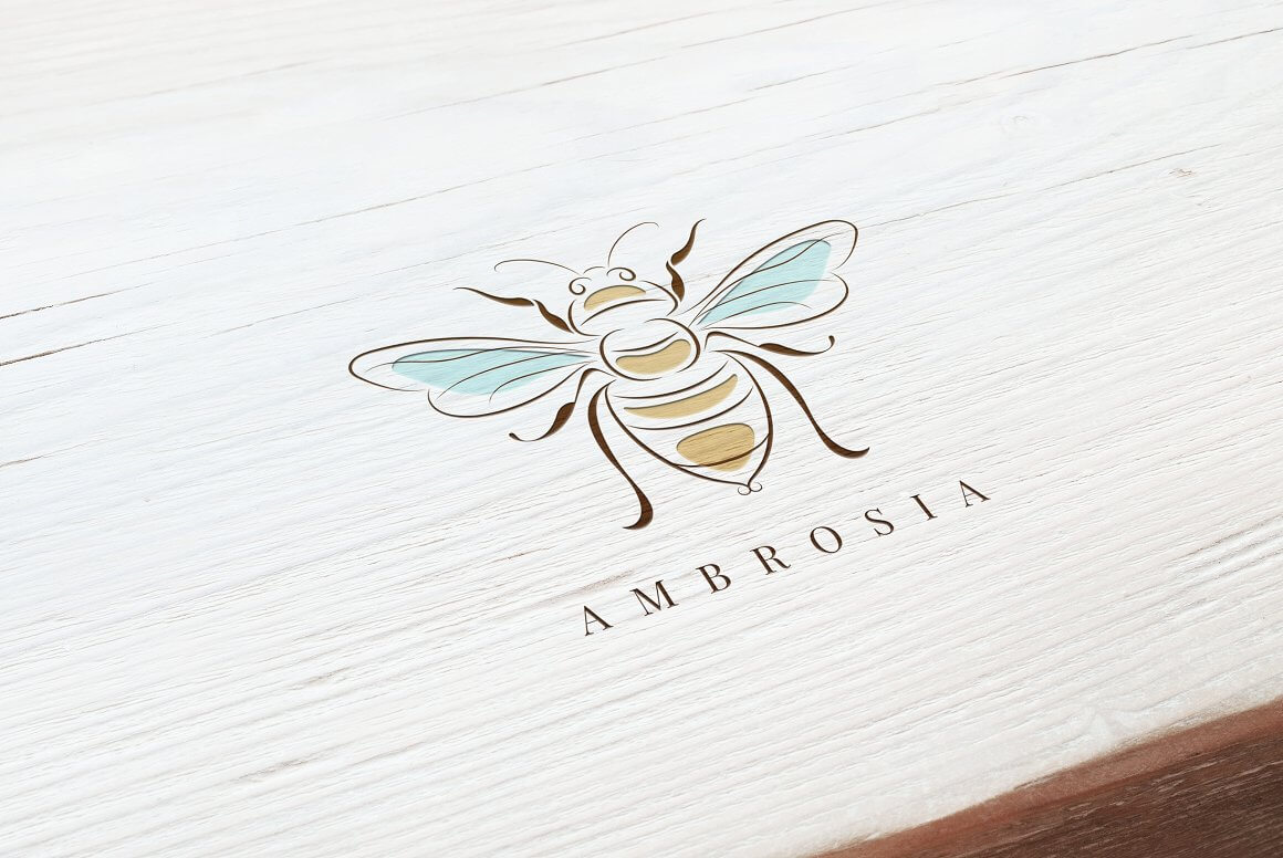 Ambrosia logo on a white wooden background.