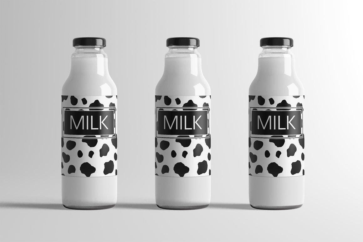 Three white bottles black and white for milk.